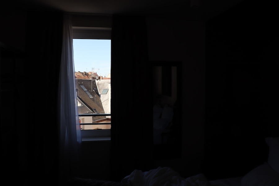 Aperçu des toits ensoleillés à travers une fenêtre, le reste sombre